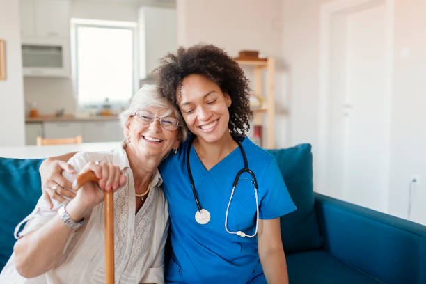 A carer sitting with an older woman